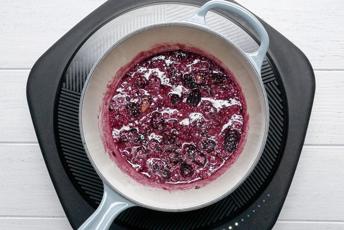 Cooking blackberries in a large sauce pan