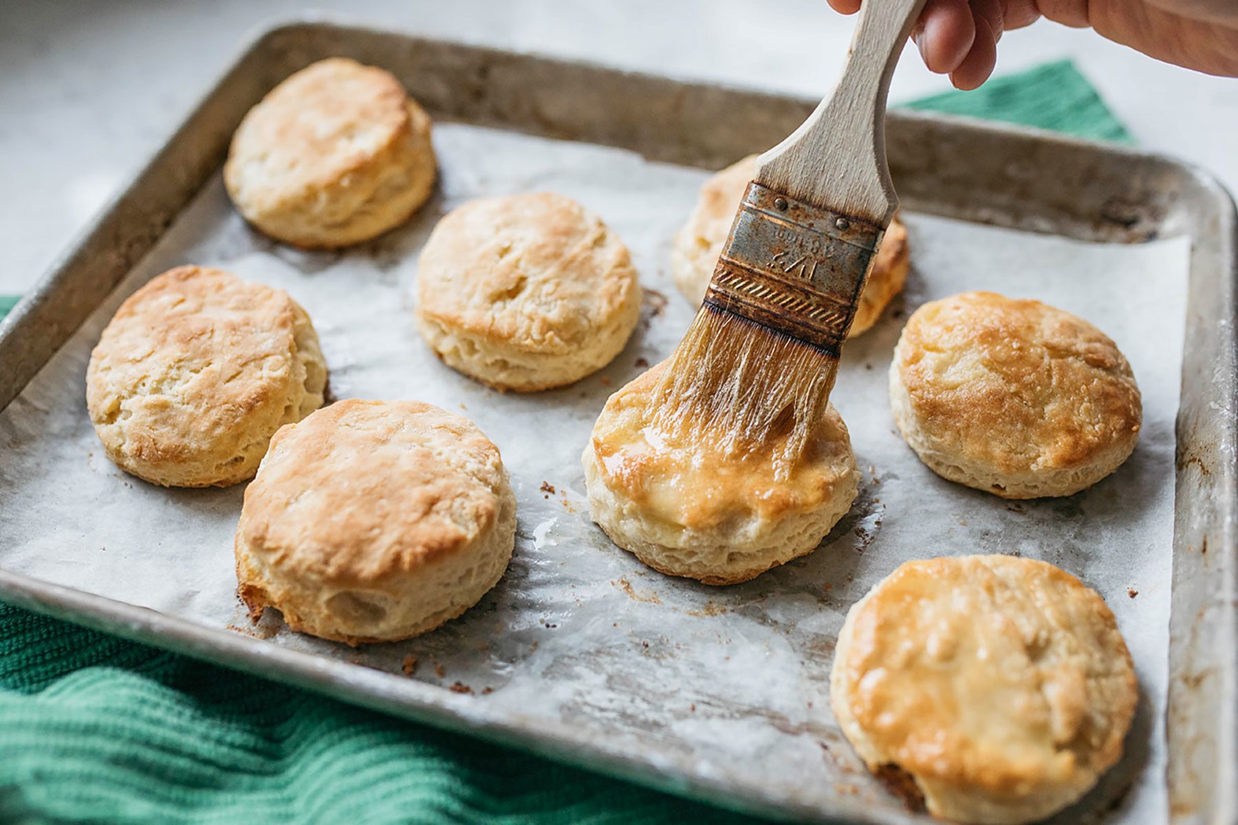 Brushing biscuits with butter
