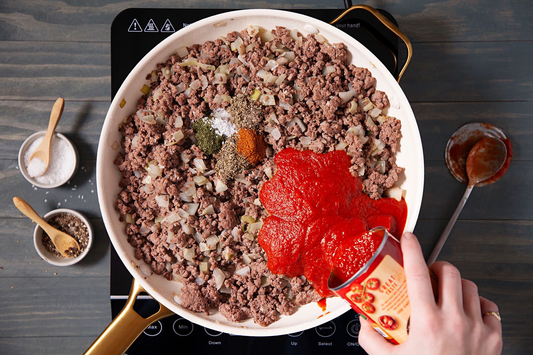 Adding sauce to beef mixture in sauce pan