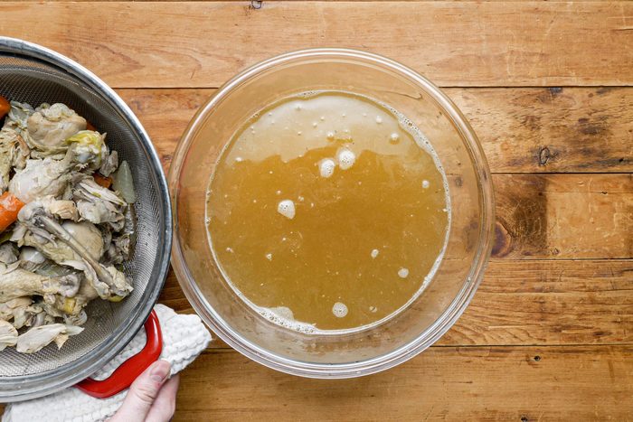 Chicken broth in a glass bowl on the table