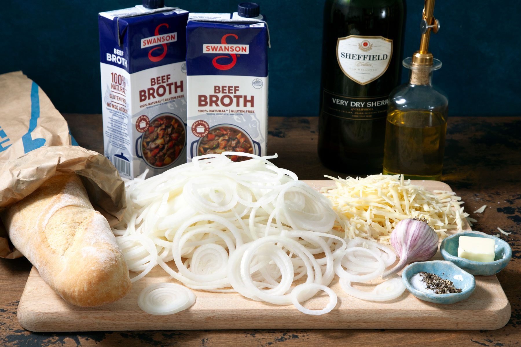 Onion cheese bread and other ingredients on a wooden tray.