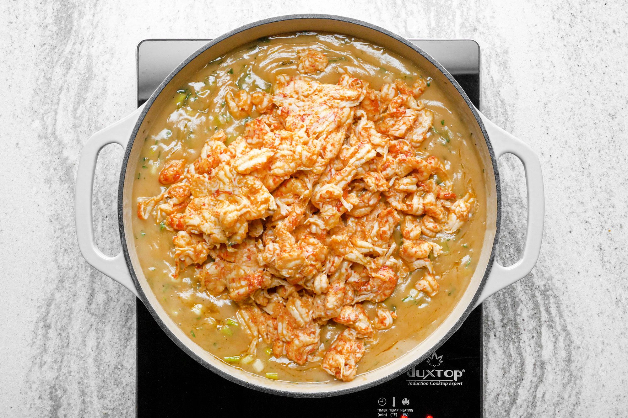 Remove bayleaf and then stir crawfish in the skillet