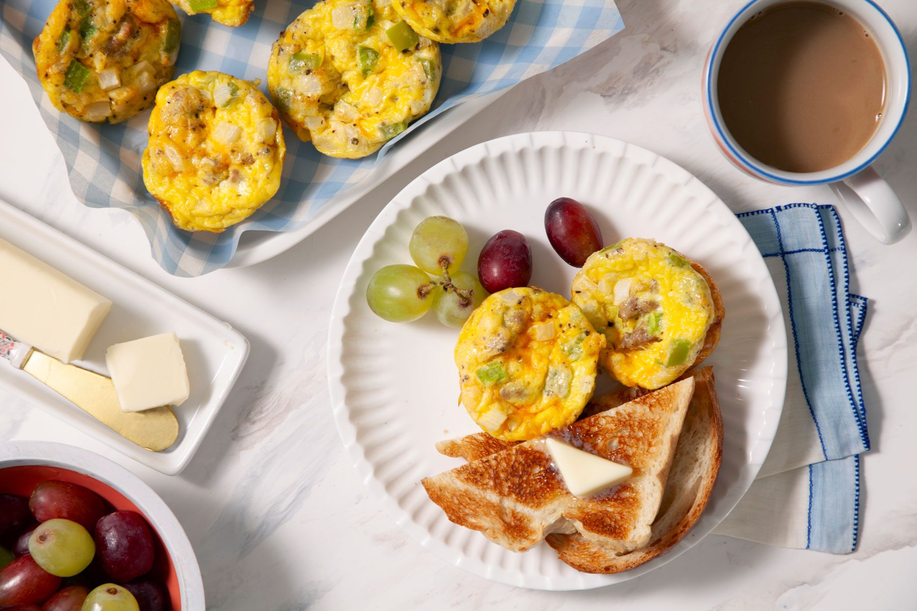 Egg Muffins served in a plate with bread toast tea and fruits