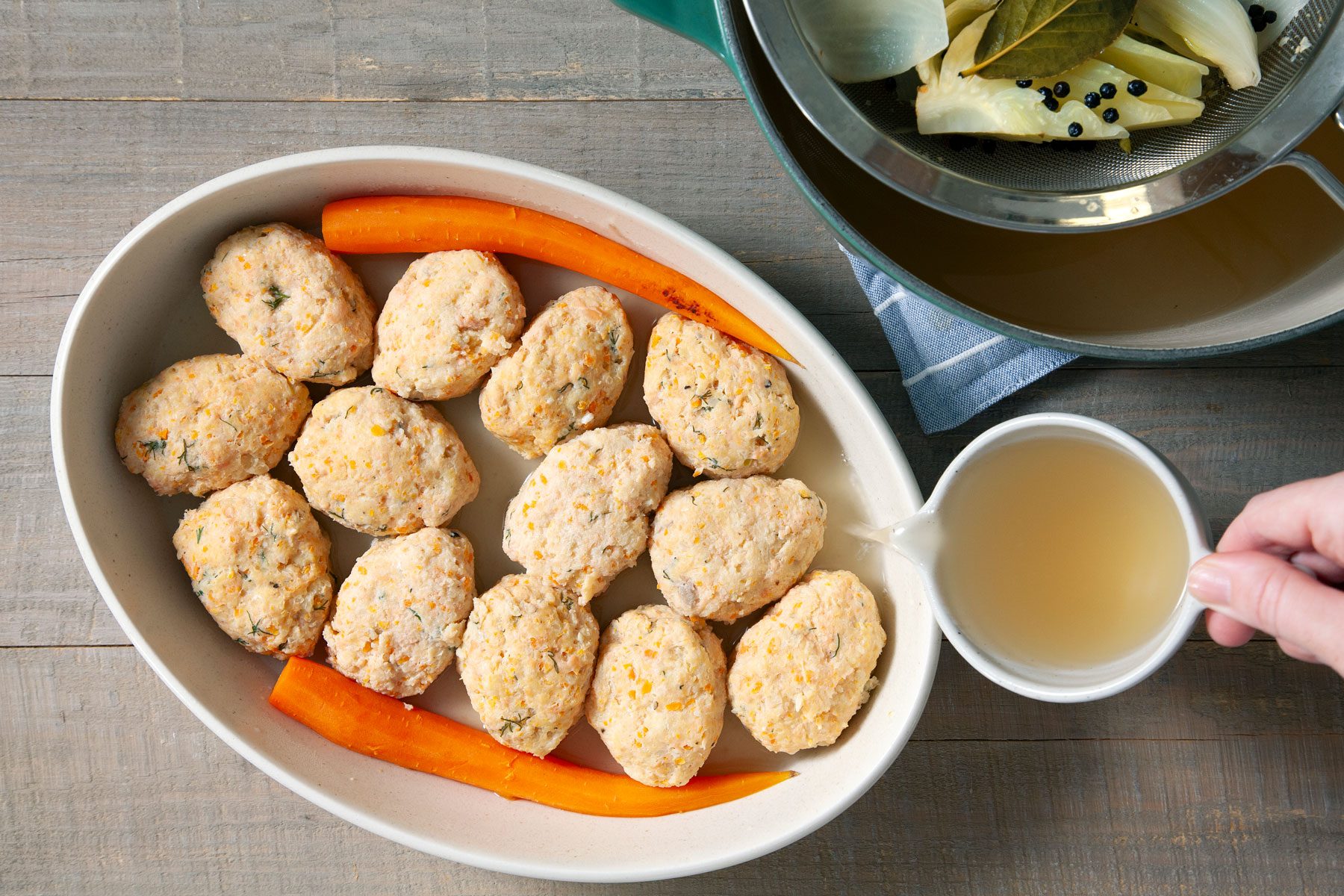 Pouring some of the liquid over the fish in a small tray