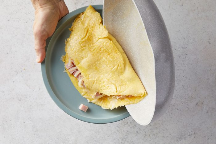 Sliding the folded omelet on plate