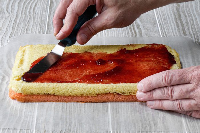 Spreading jam on cake