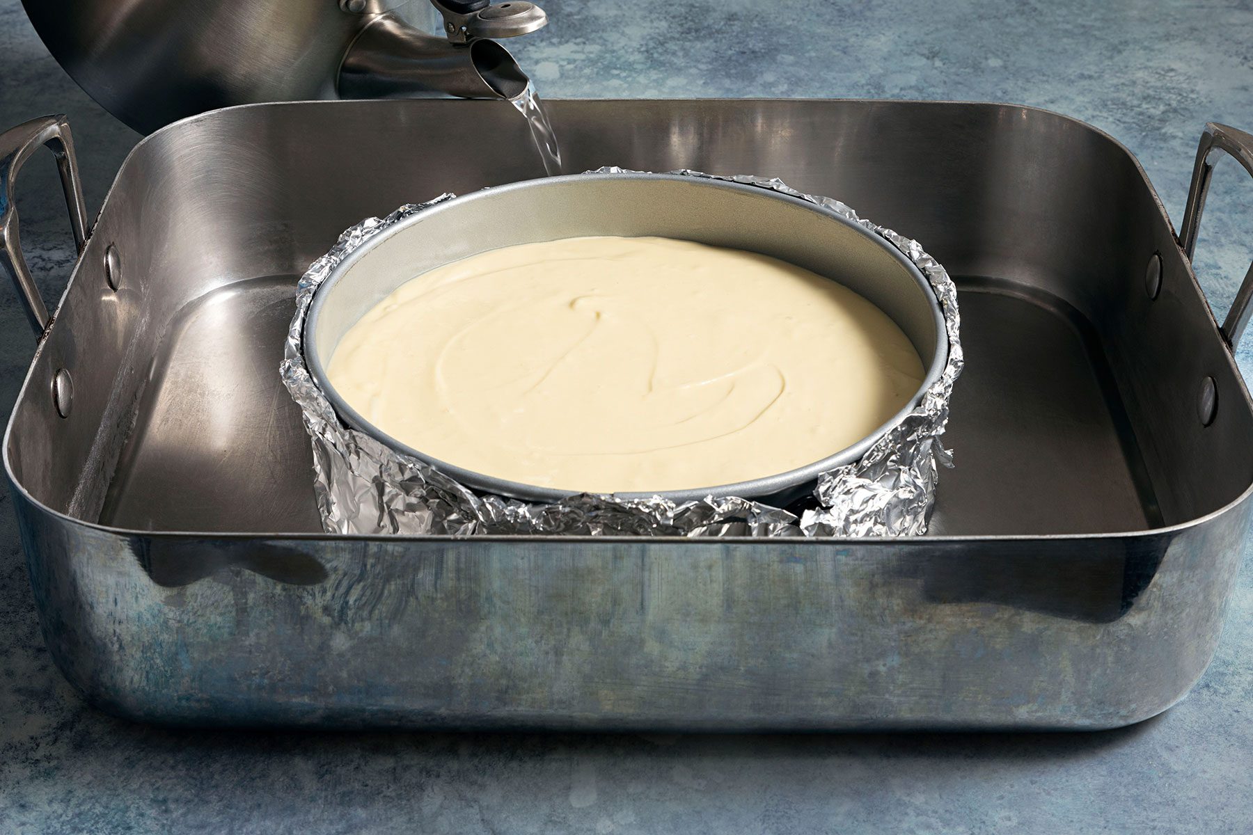 Adding water in large baking pan