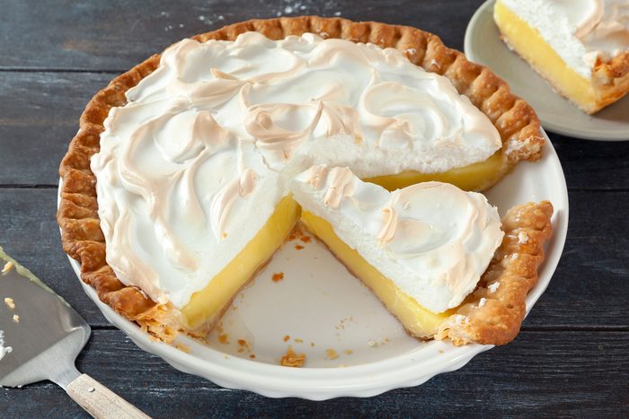 Lemon Meringue Pie served in a plate on a wooden surface
