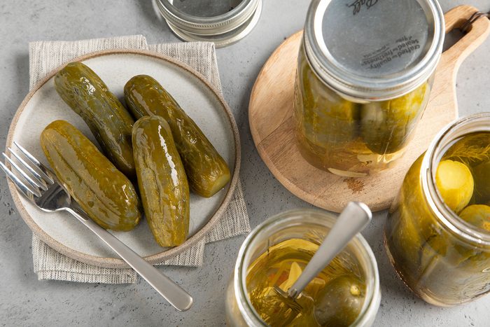 Old Fashioned Garlic Dill Pickles served on plates with fork