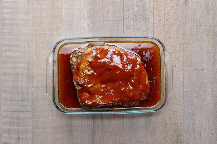 Glazing the brisket with barbecue sauce