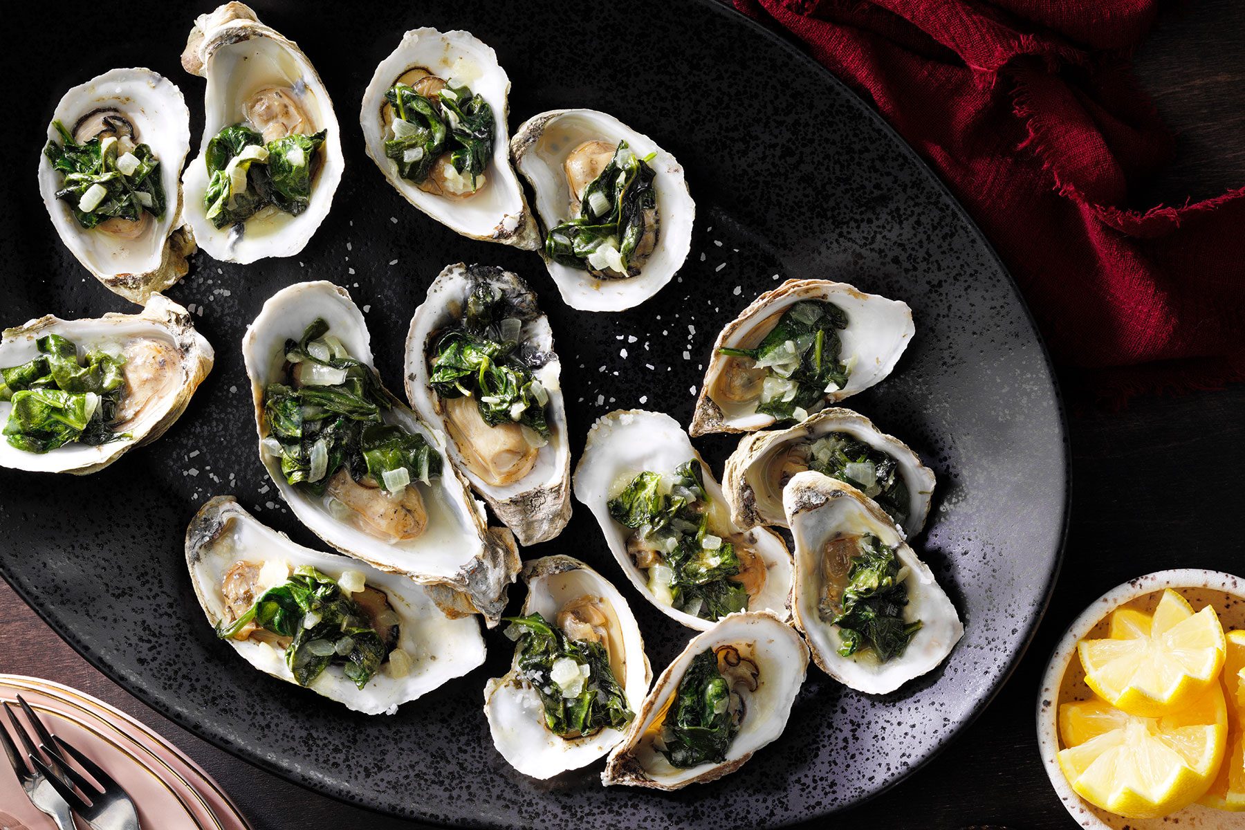 Oysters Rockefeller served in black plate