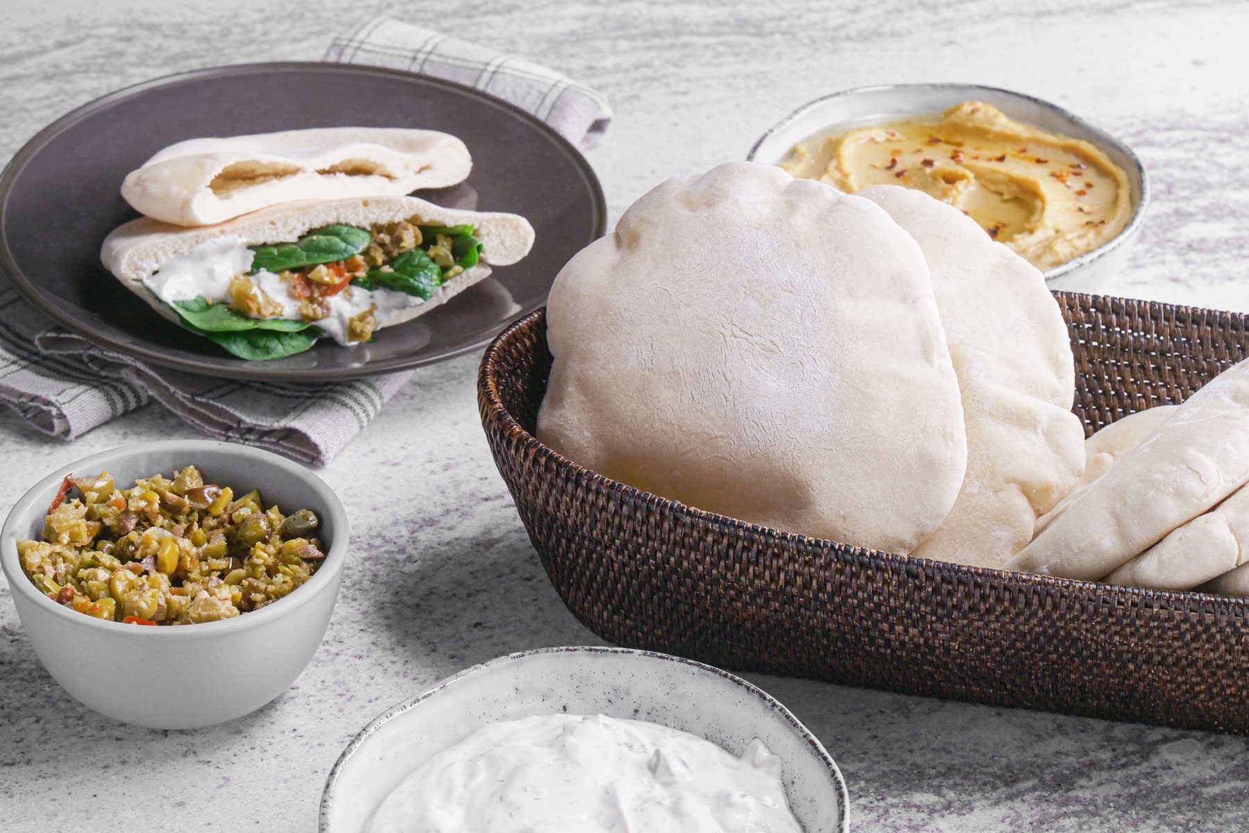 Pita Bread in a basket and served in a plate stuffed with vegetables