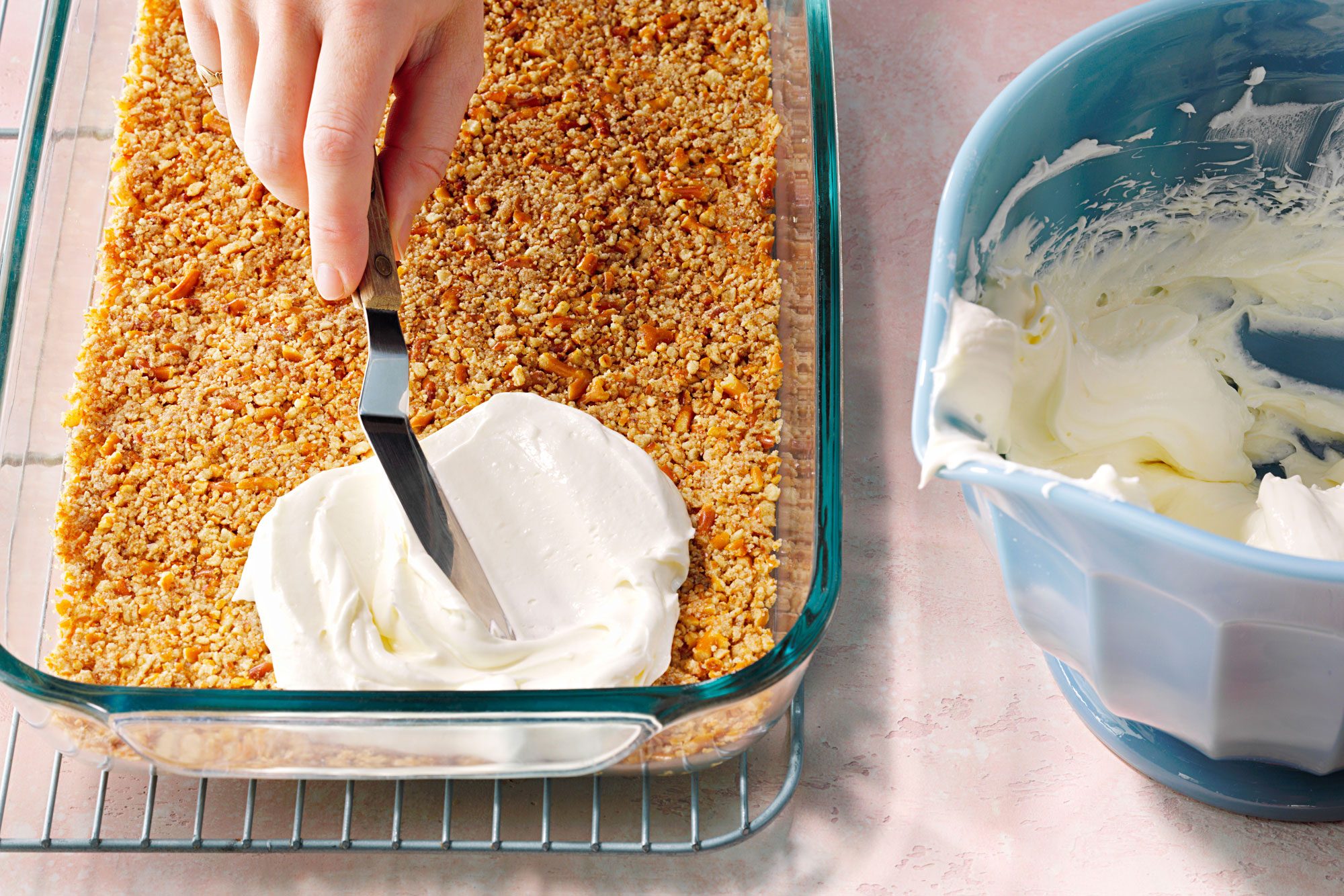 Spread cream cheese over the pretzel crust