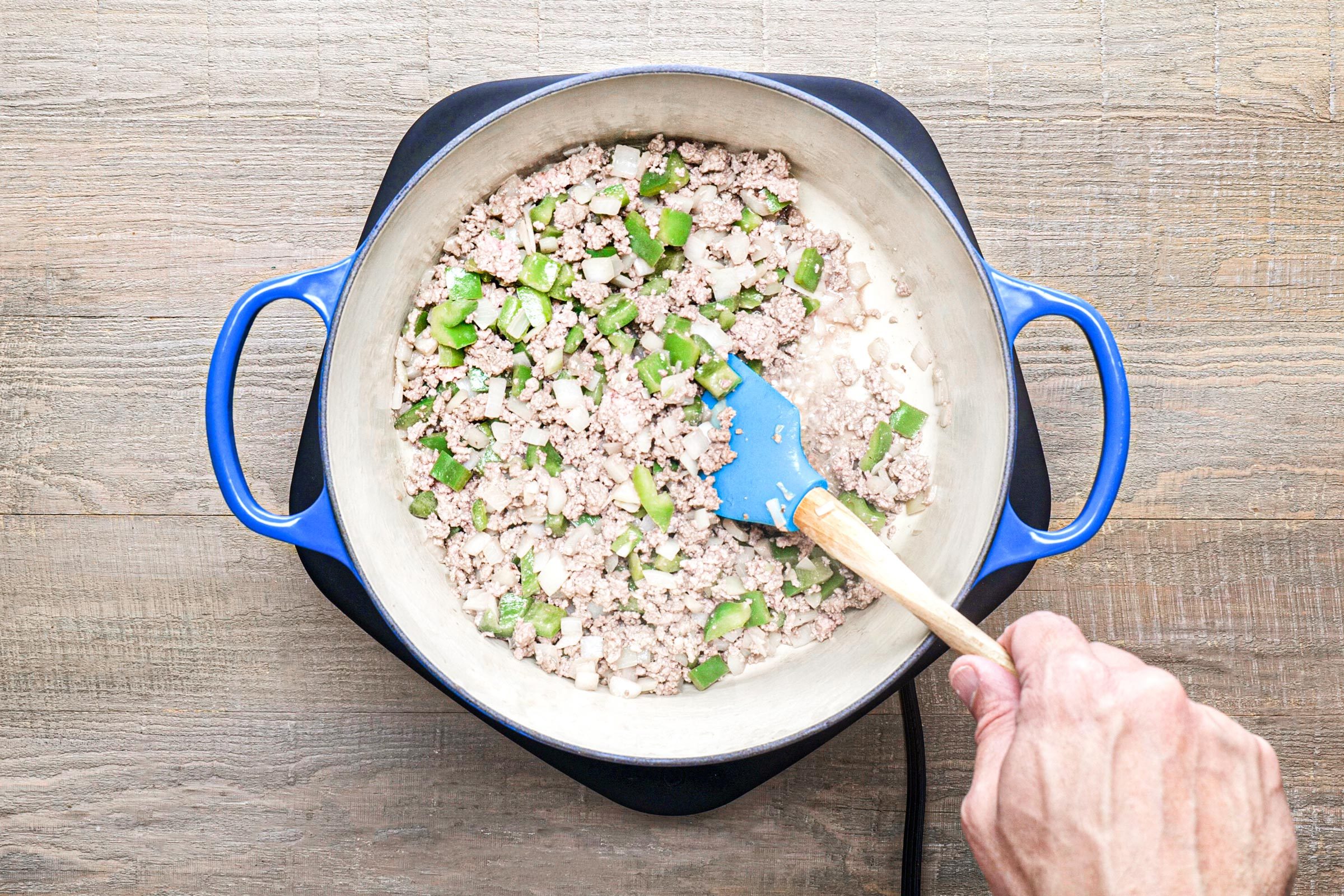 cooking meat with onion and peppers