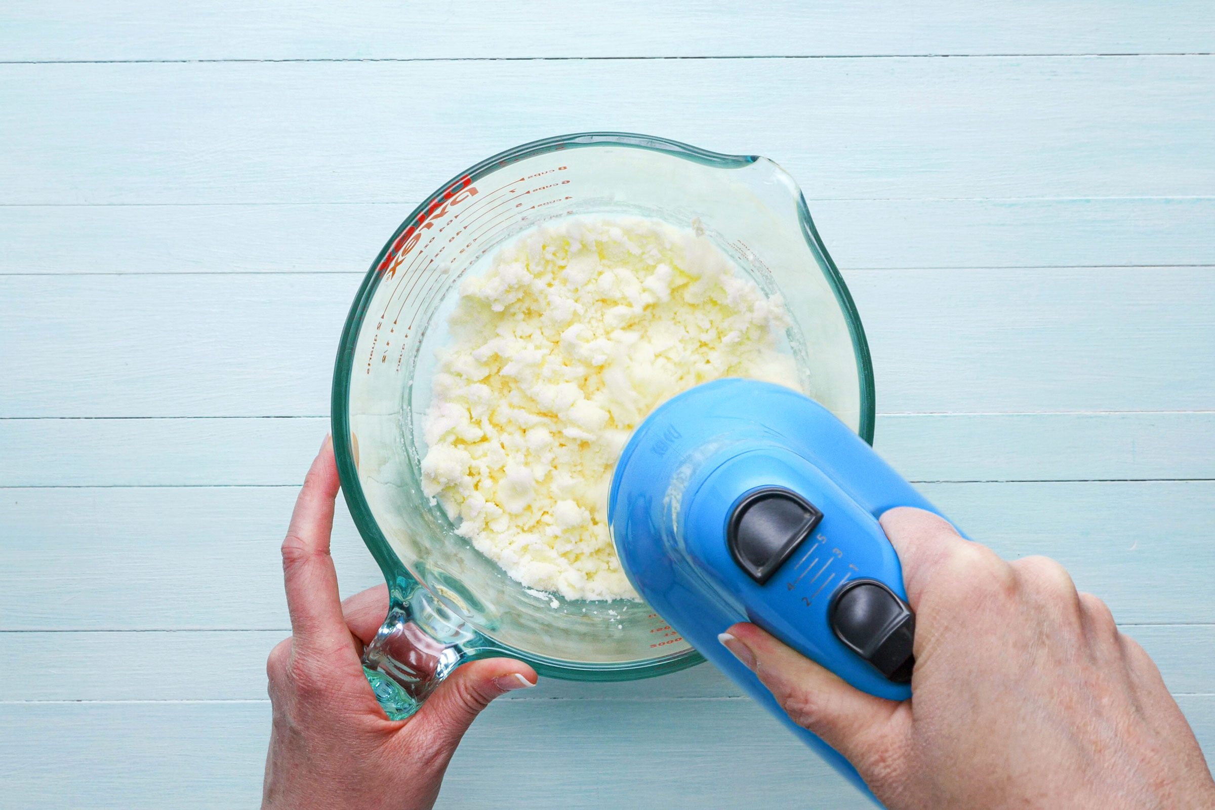 creaming butter and vanilla in a bowl with a mixer