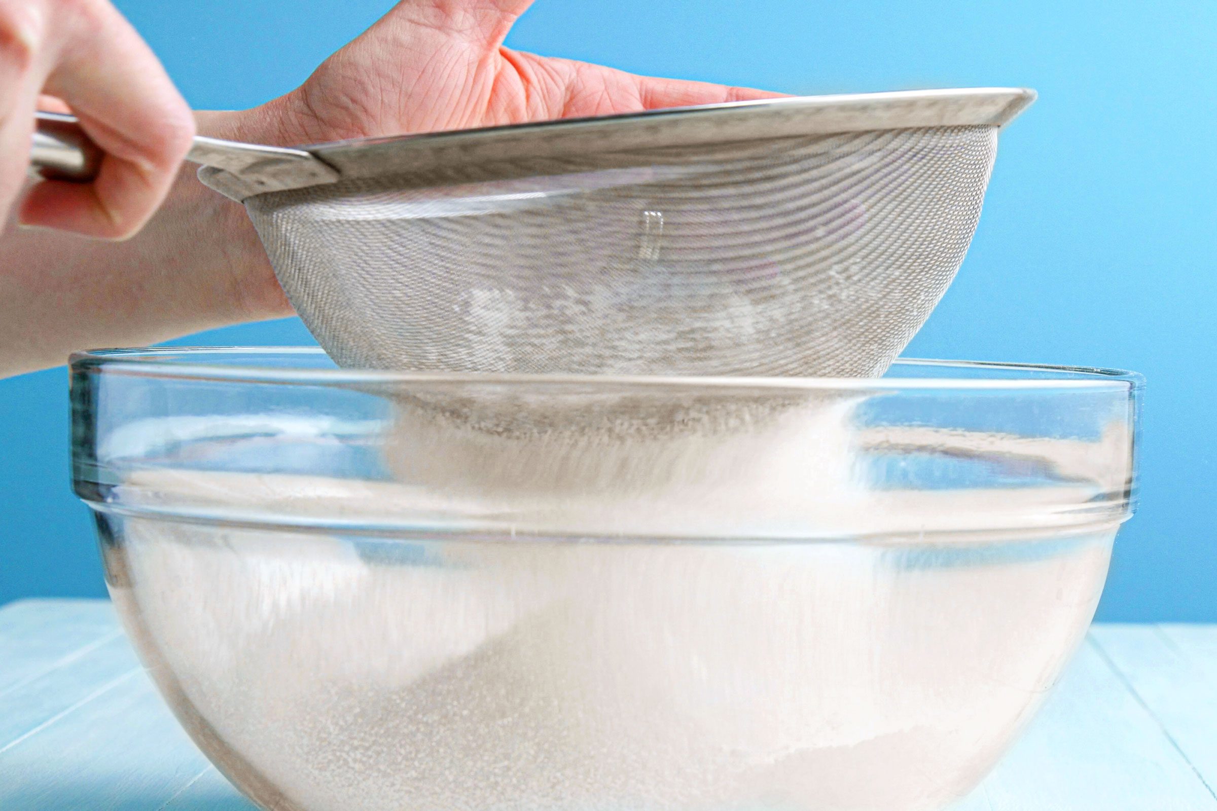 sifting dry ingredients into a bowl