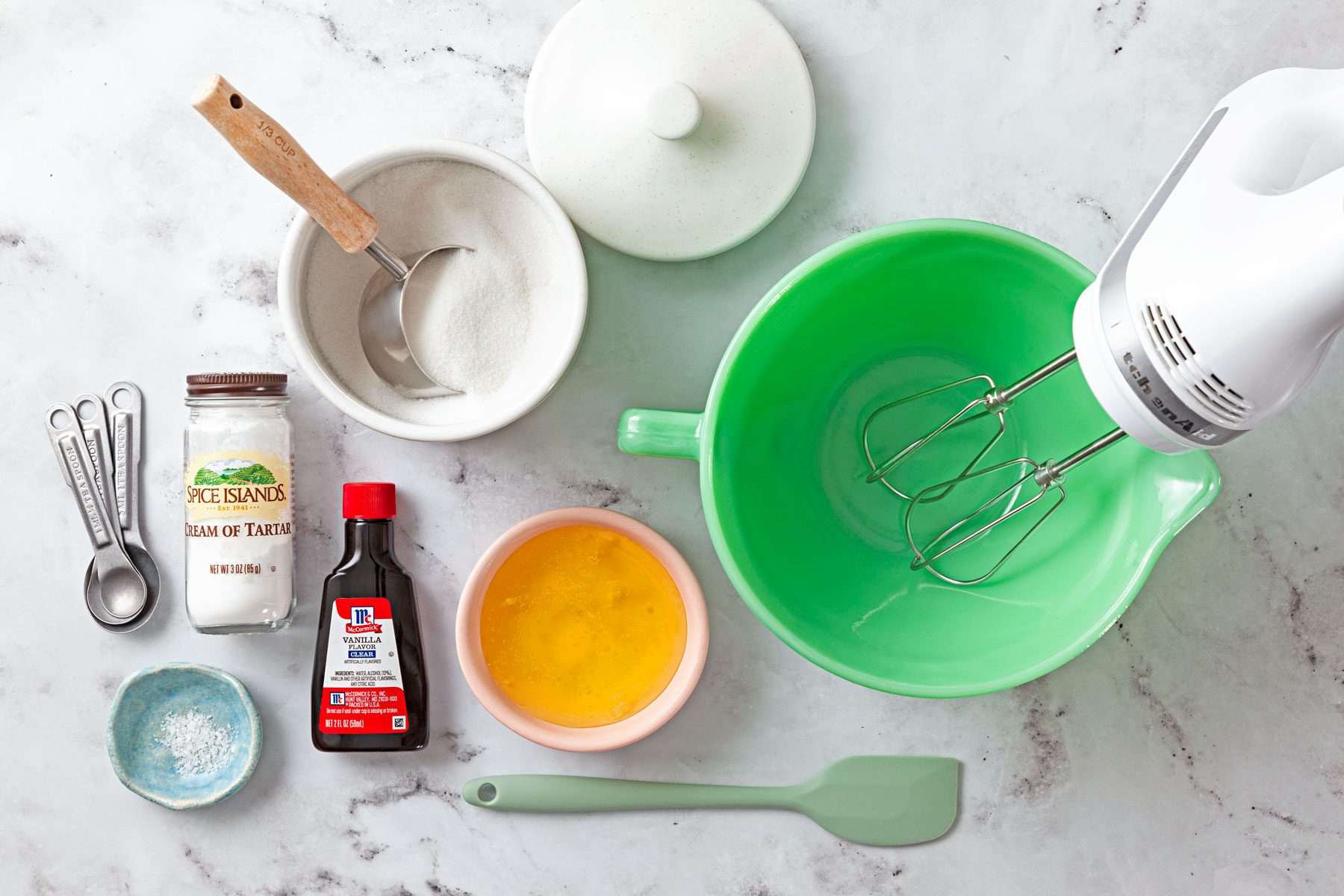Eggs, Vanilla extract and other ingredients on a white marble table