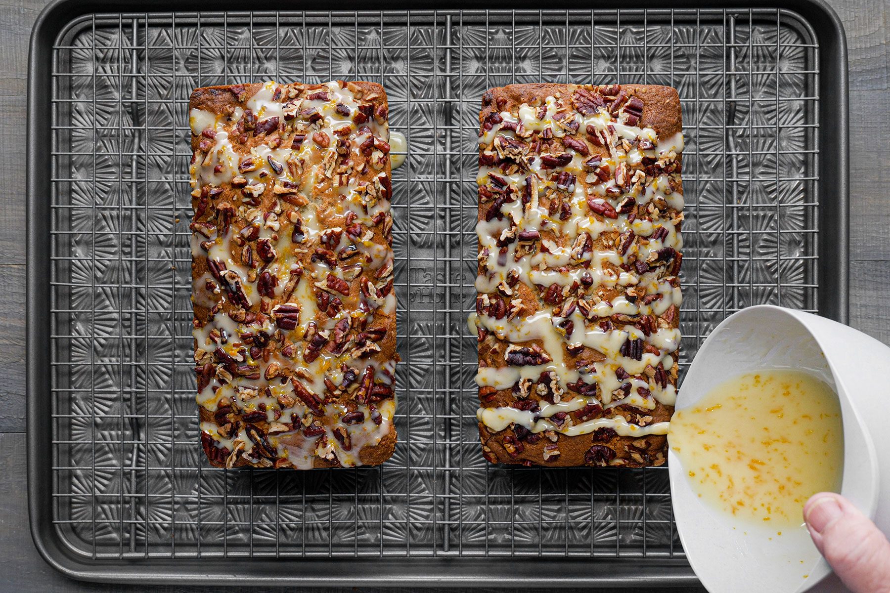 Glazing orange on Baked Banana Nut Bread cooling wire rack