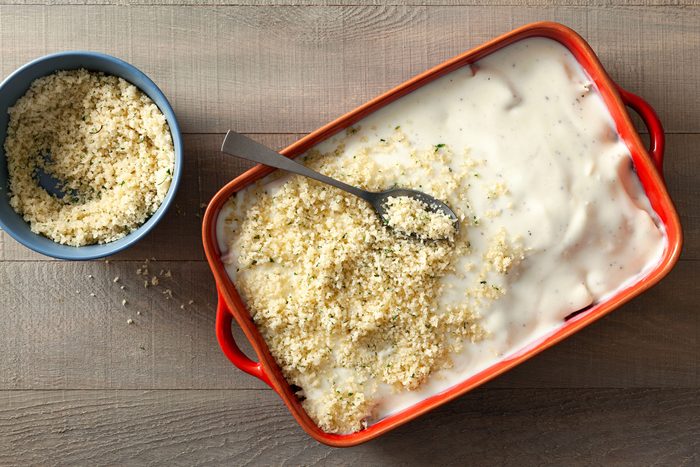 Break crumbs and a spoon the white sauce in a baking dish