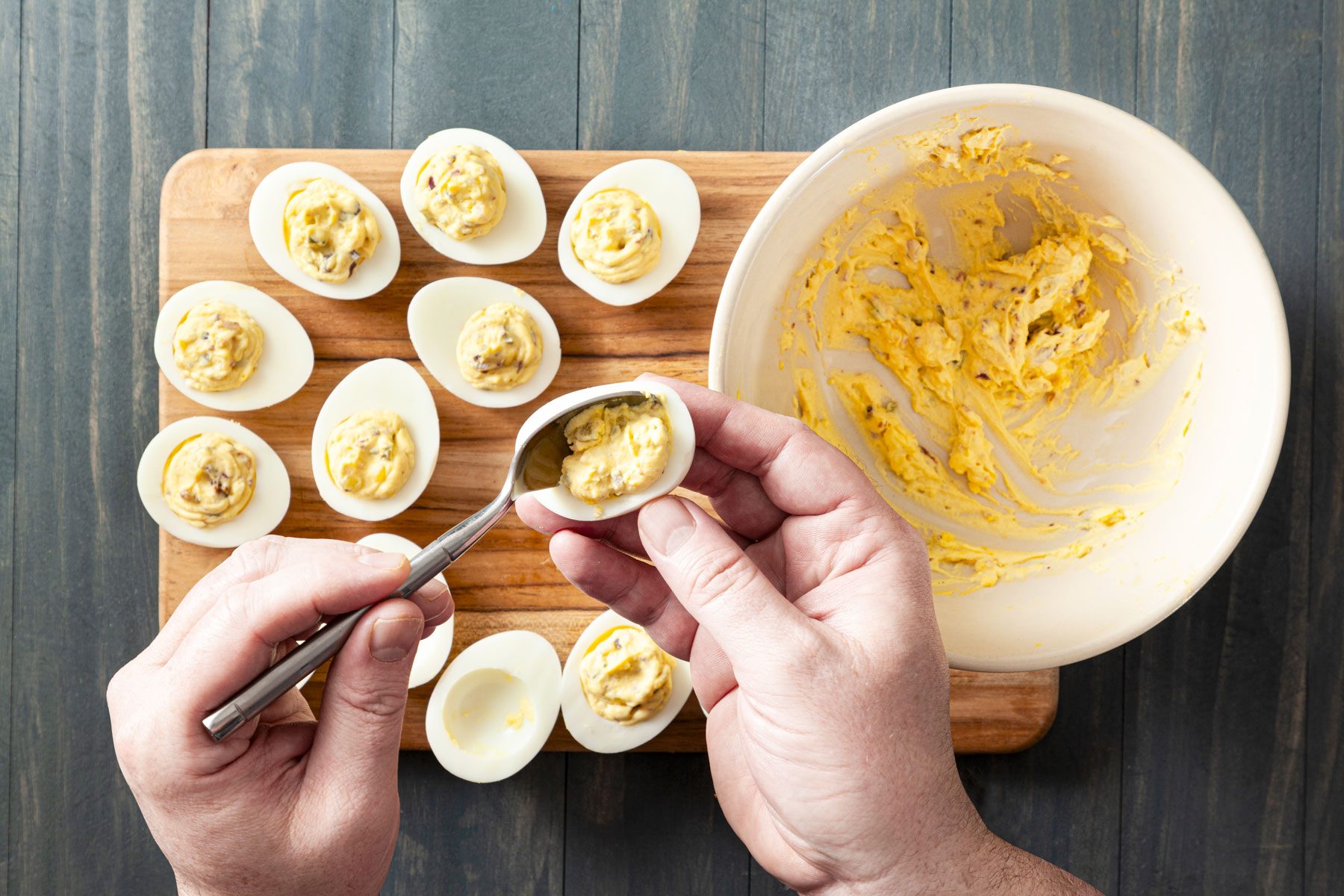 Filling the mixture into the egg whites with a spoon