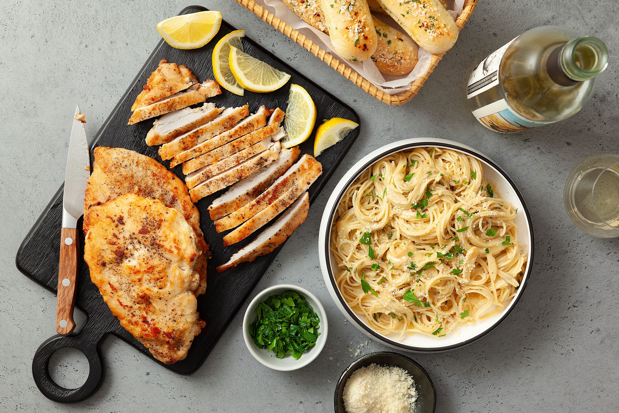 a platter of chicken and a bowl of pasta for Lemon Chicken Pasta