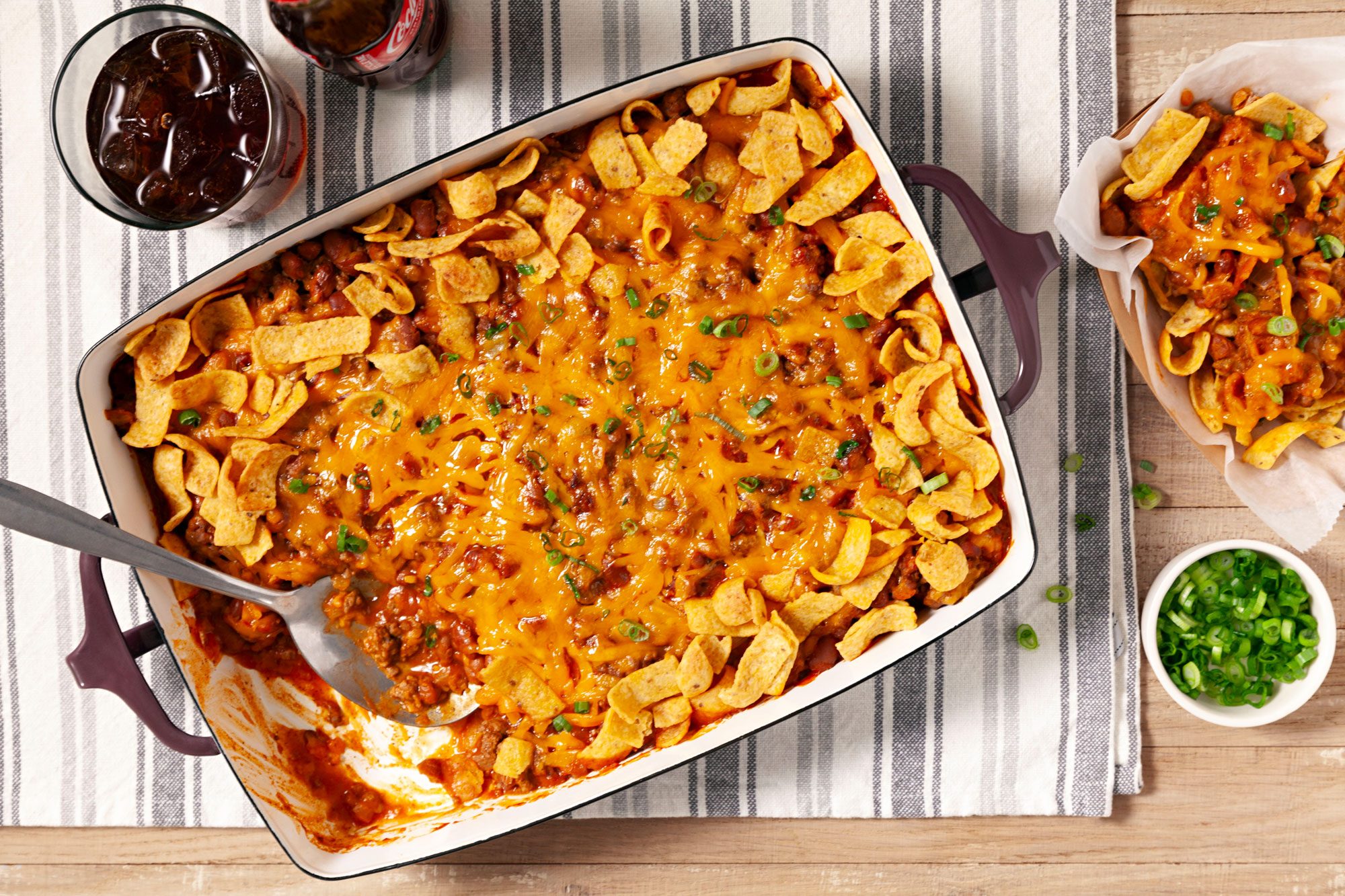 Delicious Frito Pie served with coke and green onions