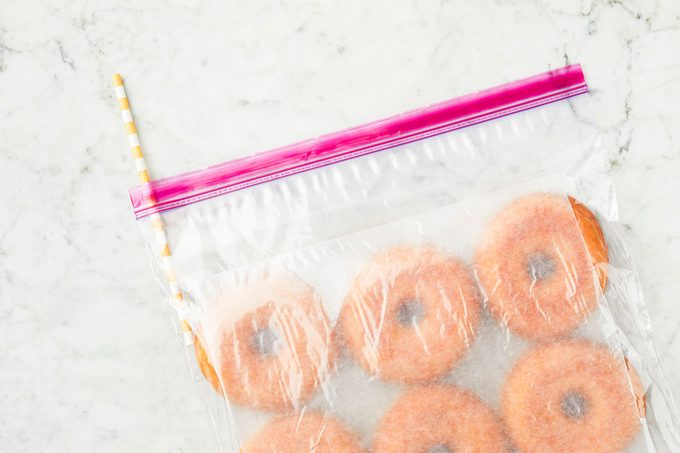 straw sticking out of bag of doughnuts packaged properly for freezing