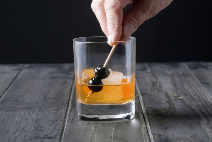 Garnish with orange peel and cherries