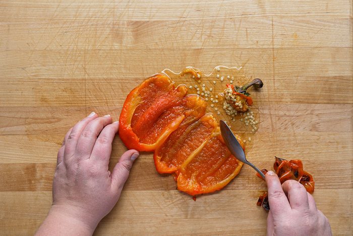Peeling off the charred skin of pepper