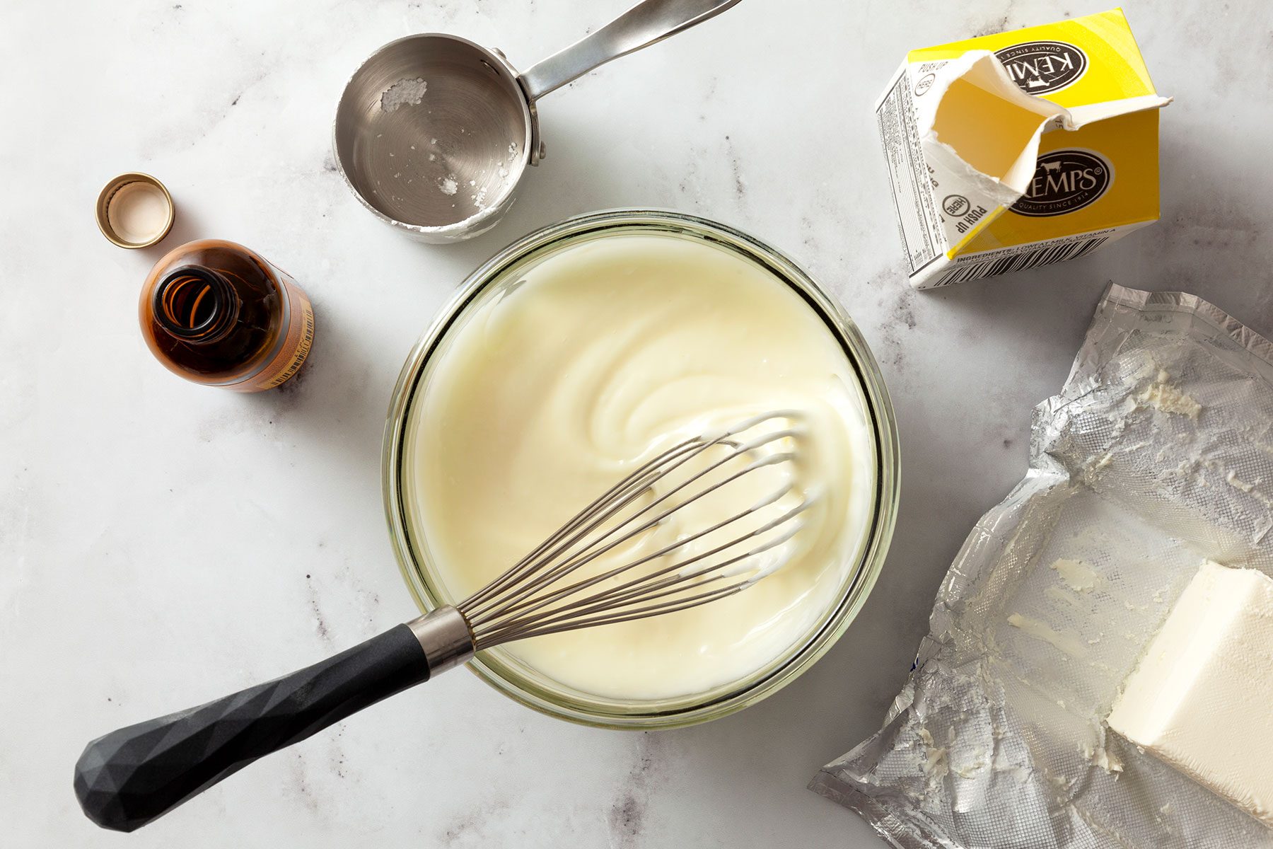 Whisking the cream in bowl to make glaze