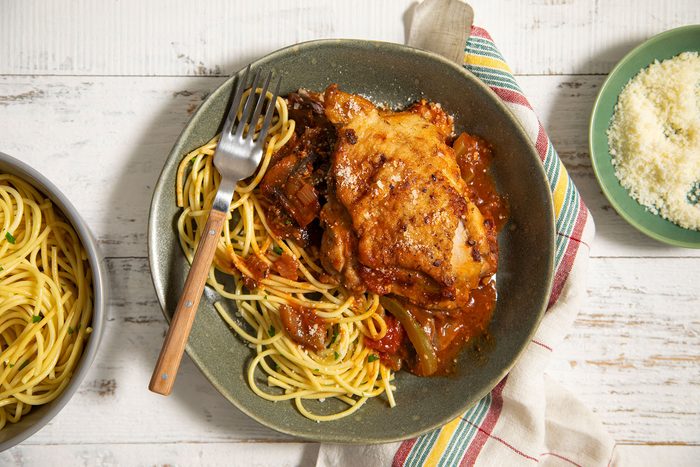 Chicken Cacciatore served on plate with pasta and cheese