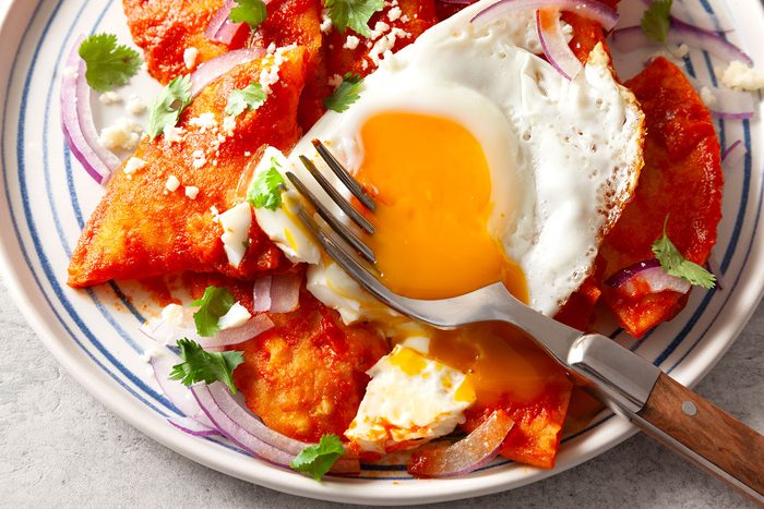 Chilaquiles served on plate with fork