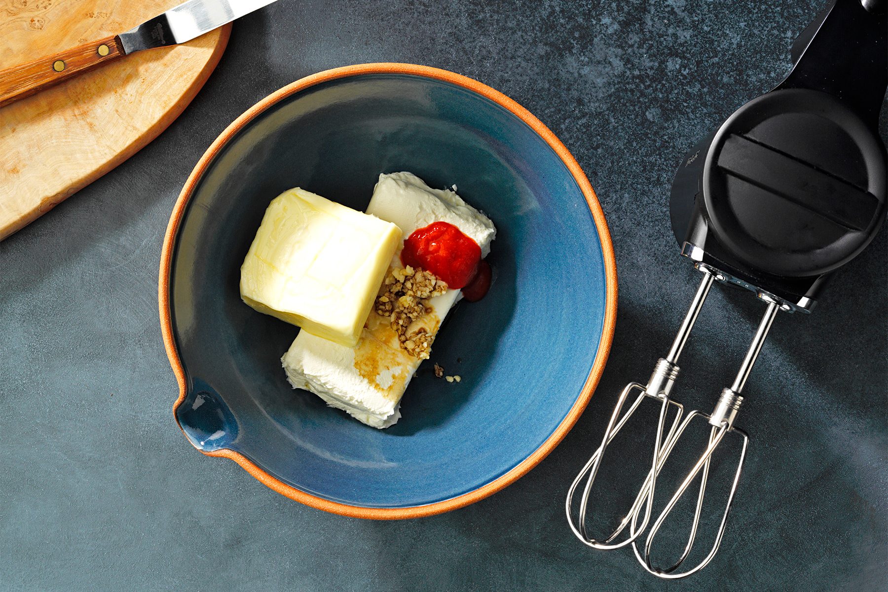 A bowl of butter and a whisk