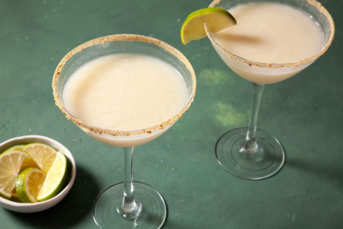 3/4th Shot of Key Lime Martini; Green background;