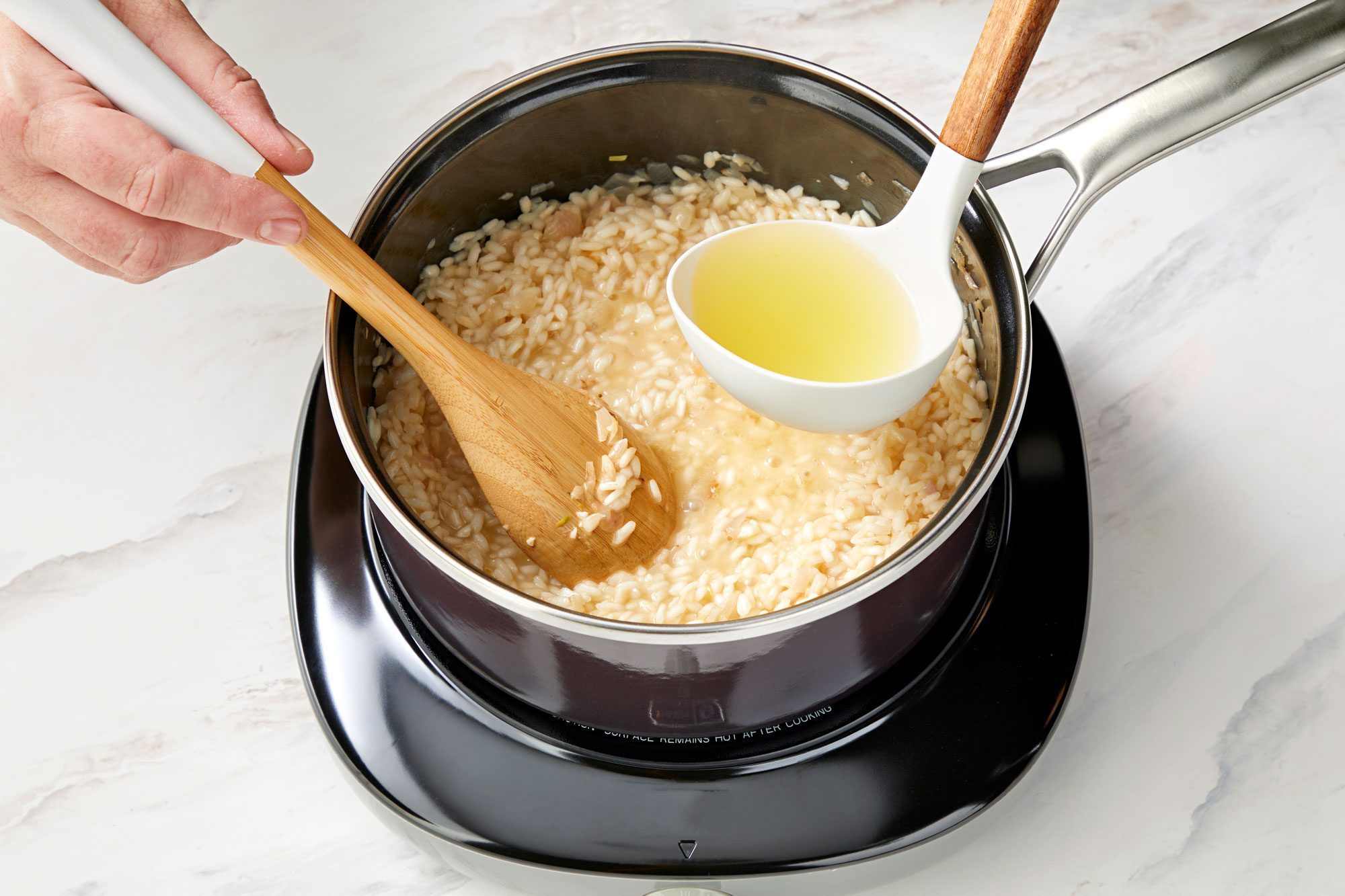 wide shot of wine added in the rice in a saucepan