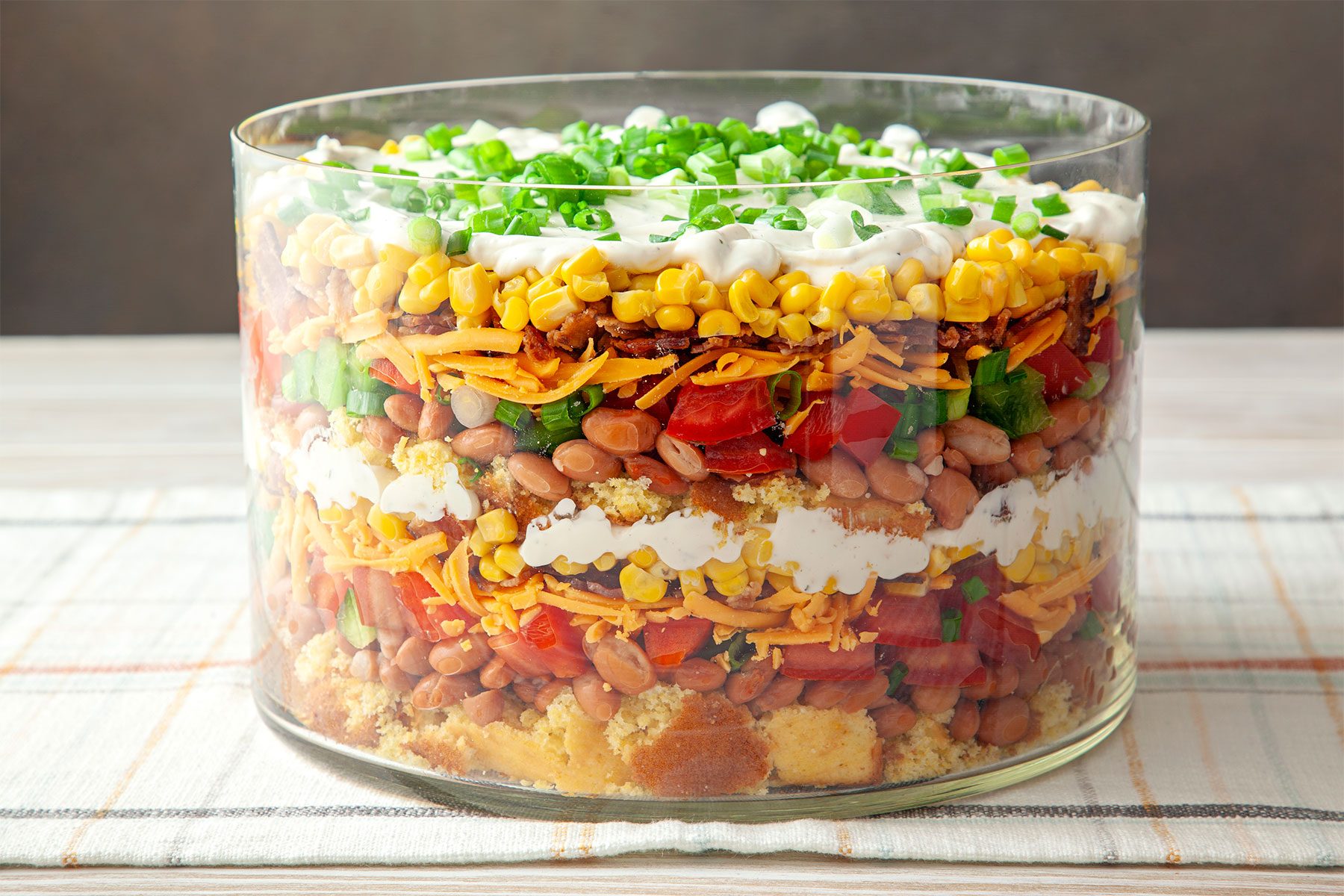 close shot of southern cornbread salad topped with green onions