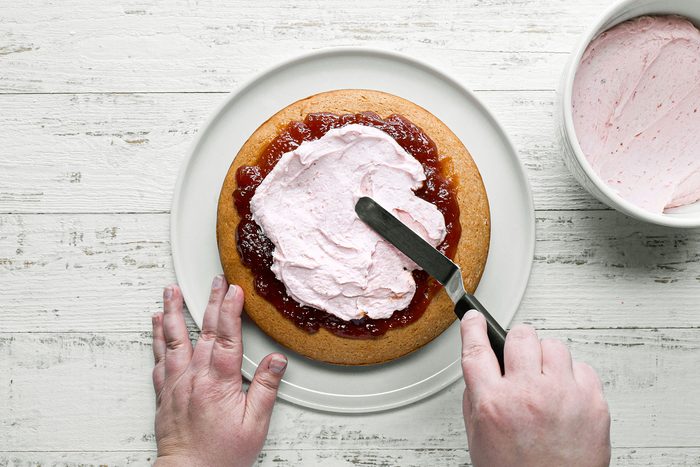 Spreading frosting on cake