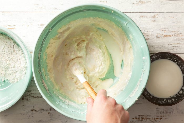 A person mixing ingredients in a bowl