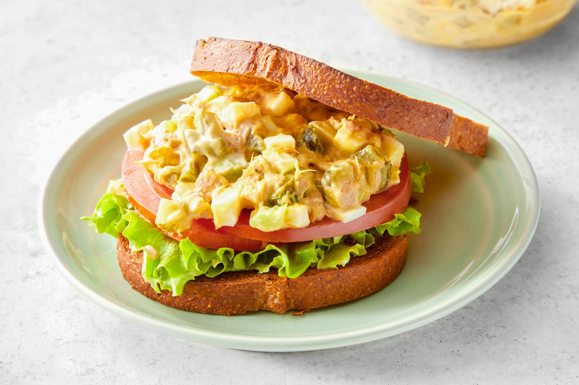 Tuna Salad With Egg and Breads served on a small plate; marble background;