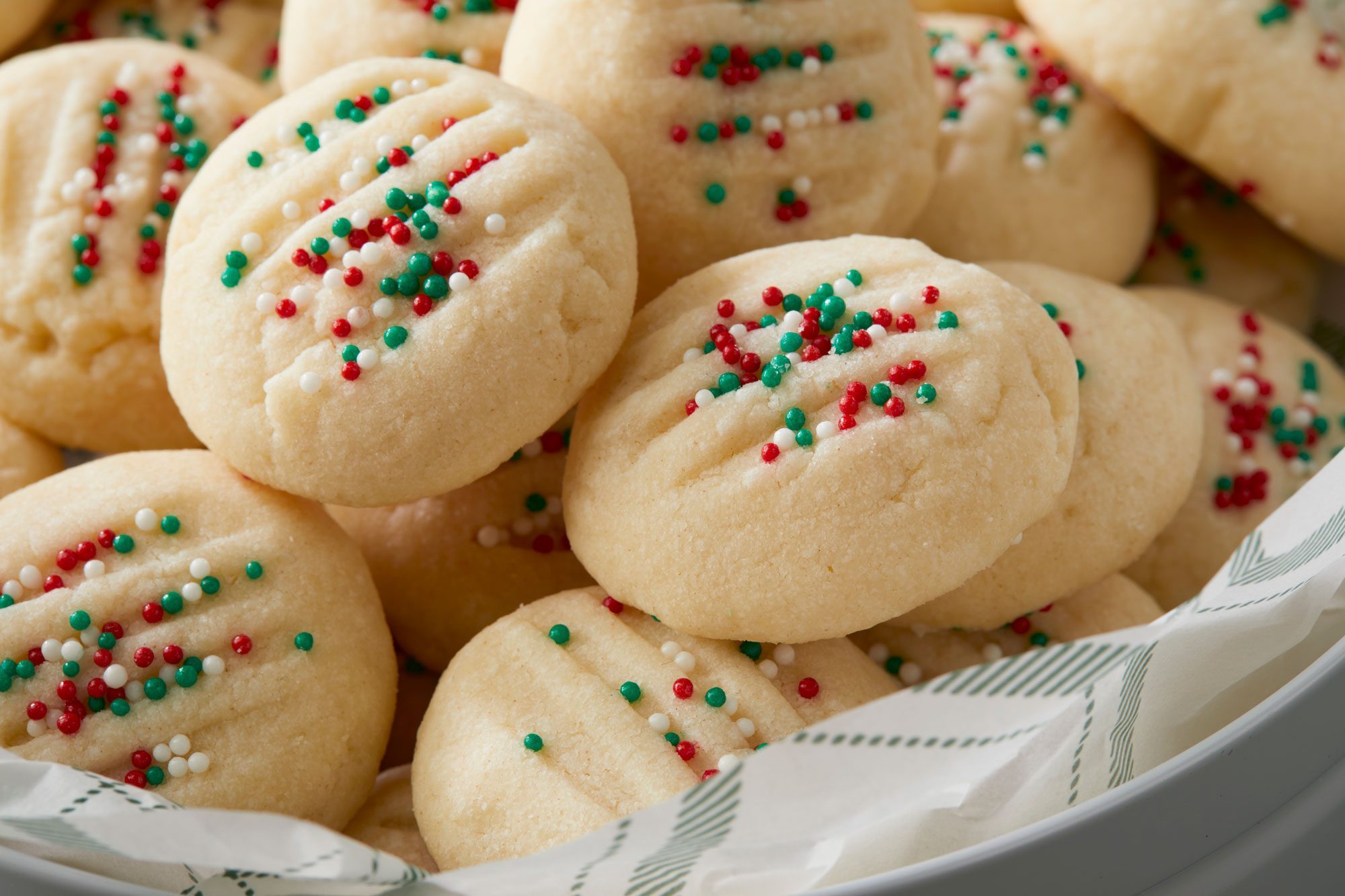 Whipped Shortbread cookies in a basket, topped with colorful sprinkles