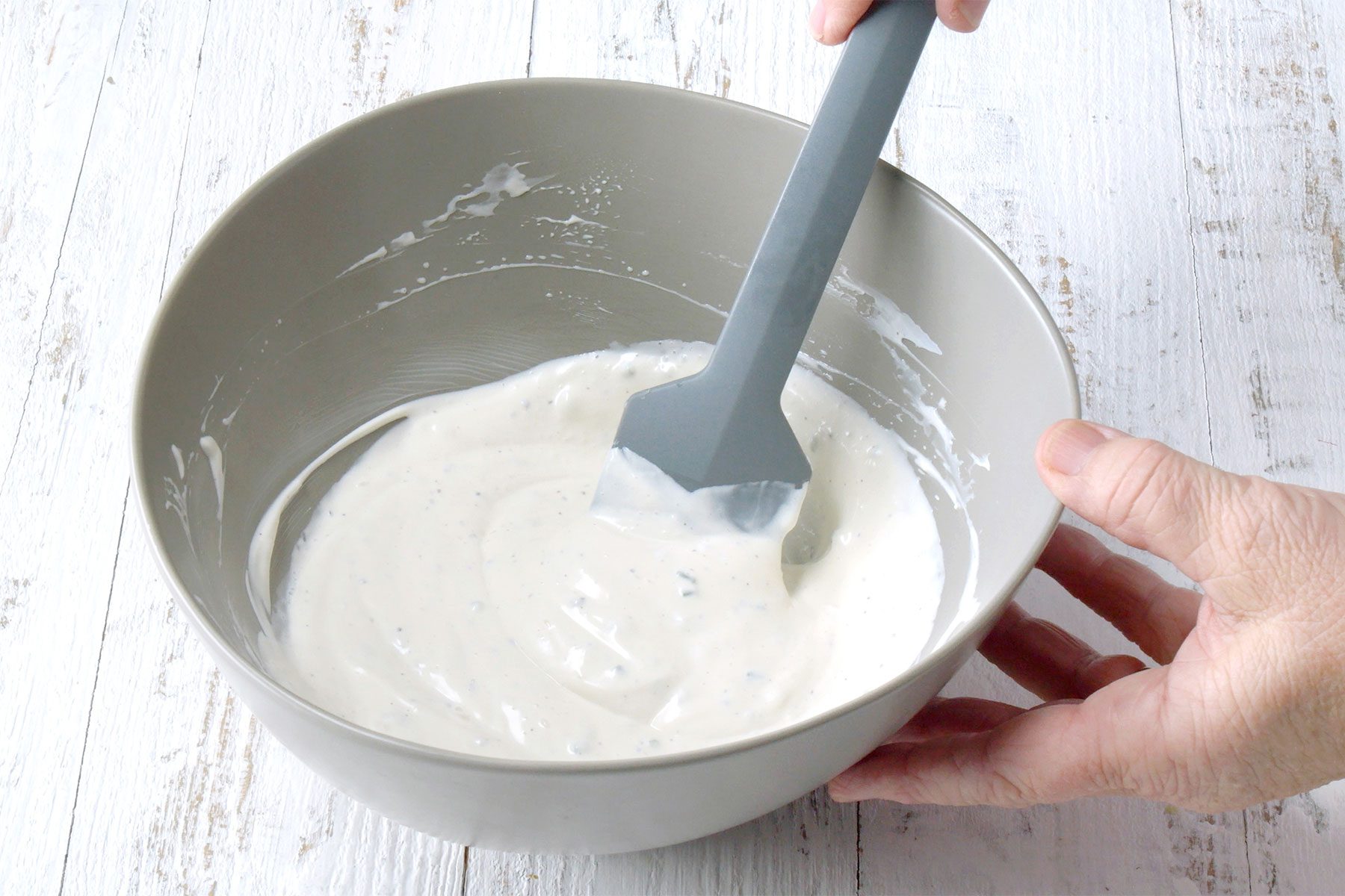 wide shot of stiring blue cheese in a bowl