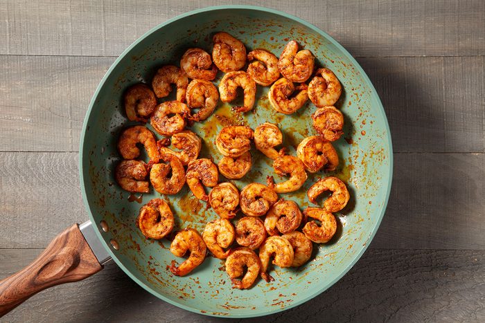 Shrimp mixed with spices in pan