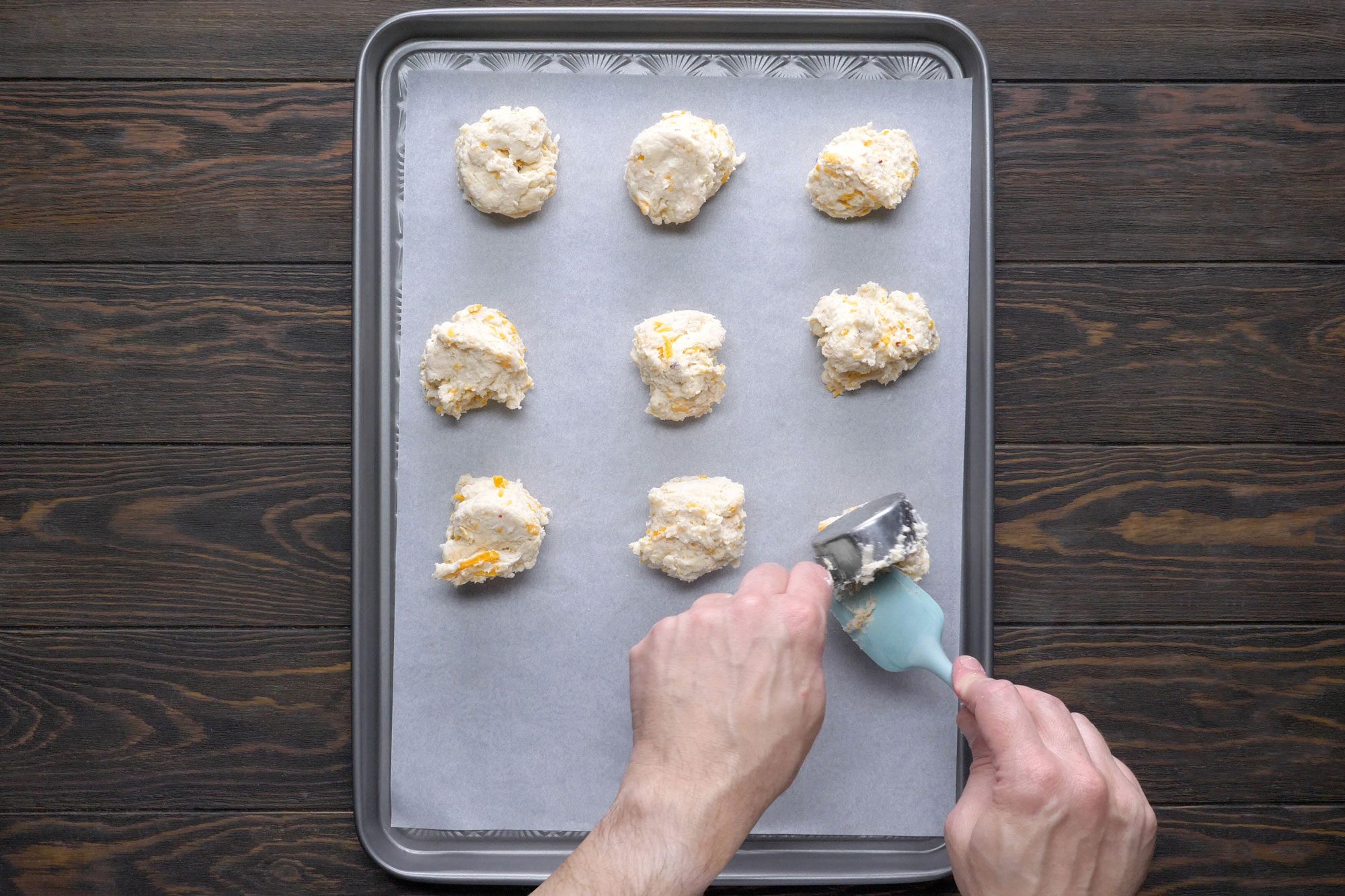 Drop dough by heaping 1/4 cupfuls on parchment-lined baking sheet