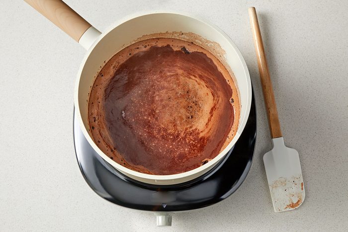 overhead shot of cocoa mix in a saucepan with spatula