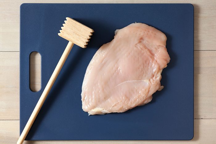 Pound the chicken with a meat mallet