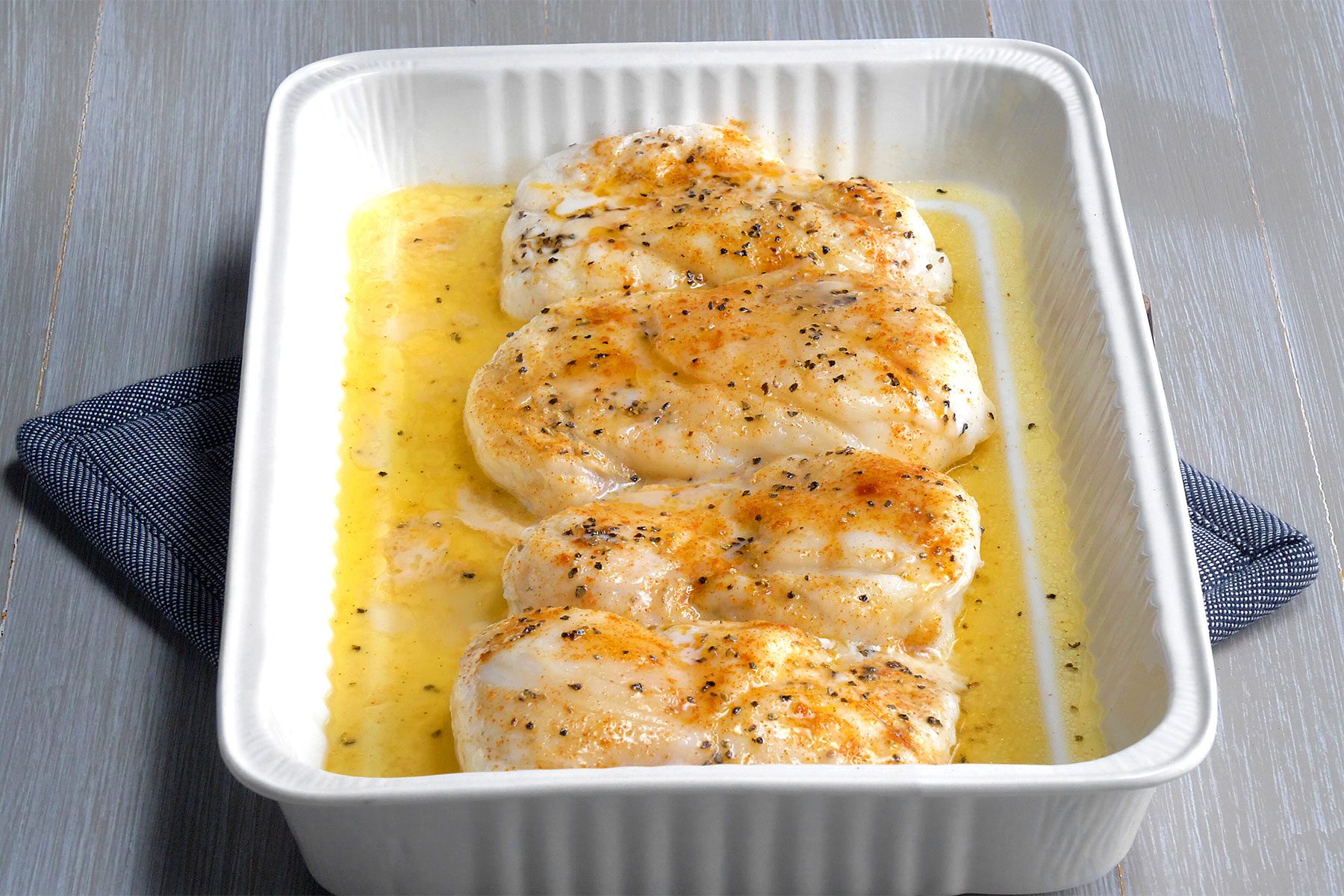 3/4 angle view shot of Fast Baked Fish; kitchen cloth; wooden background;