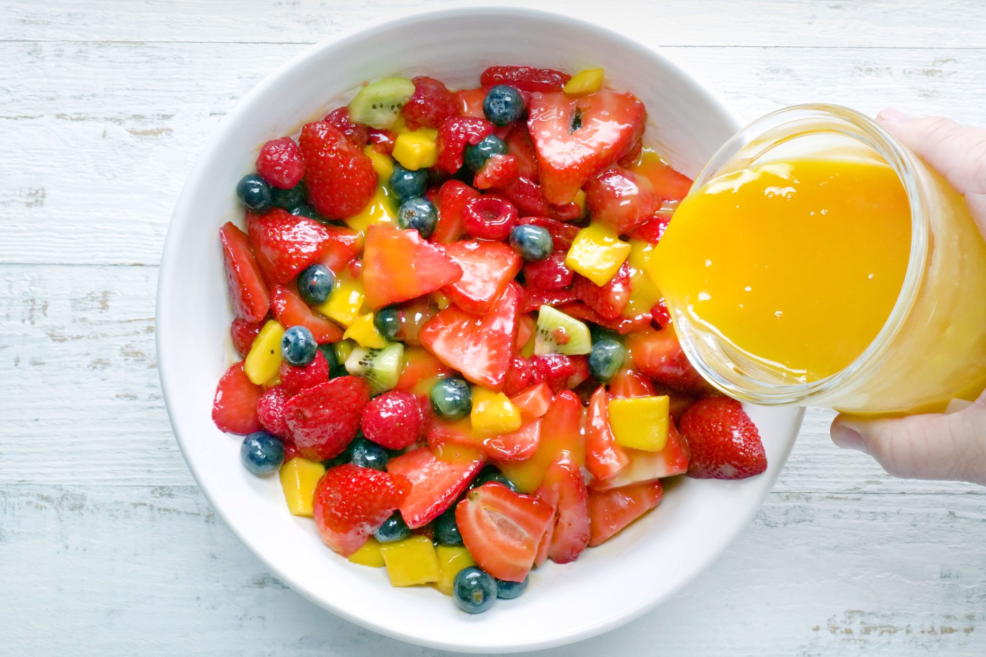 overhead shot of fruit salad dressing served over fruits