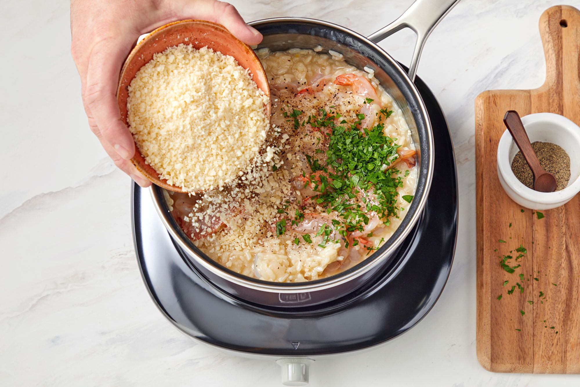 overhead shot of parmesan cheese spreaded on the shrimps