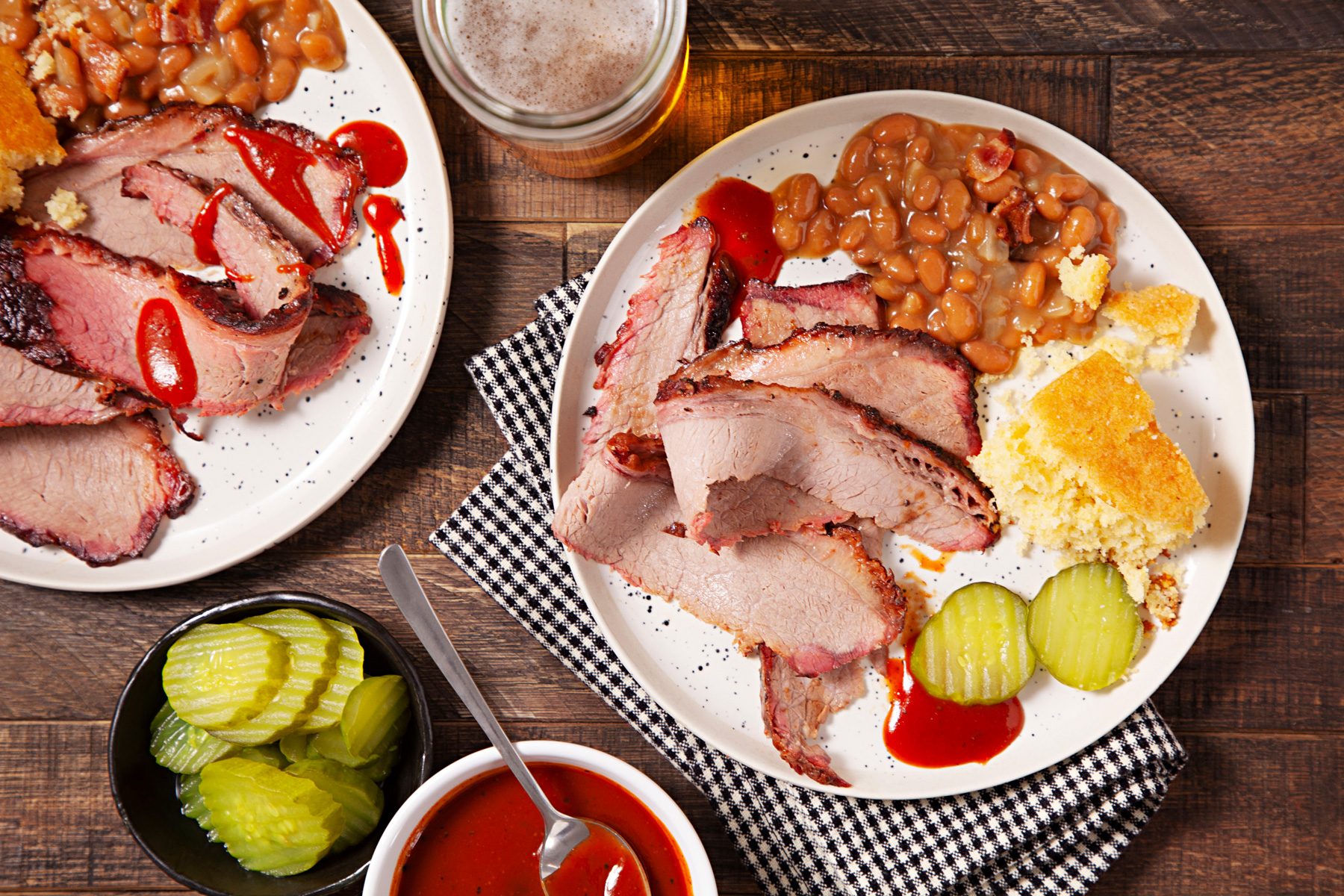 Two plates of smoked whole brisket on a table