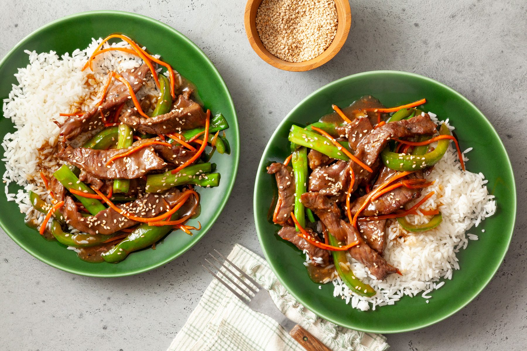 Two plates of Steak Stir Fry served with steam rice